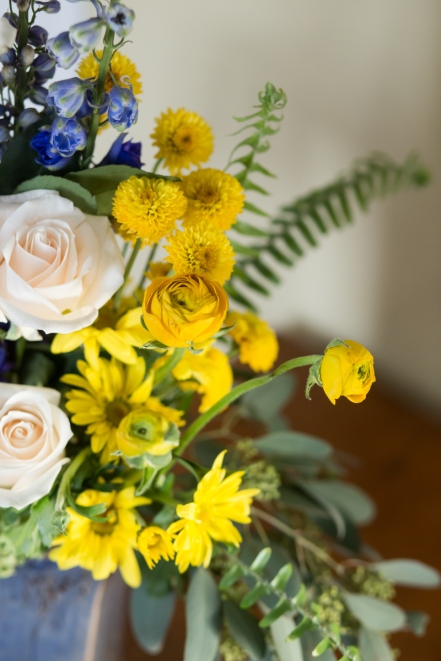 white rose yellow and blue fern outdoor centerpiece event